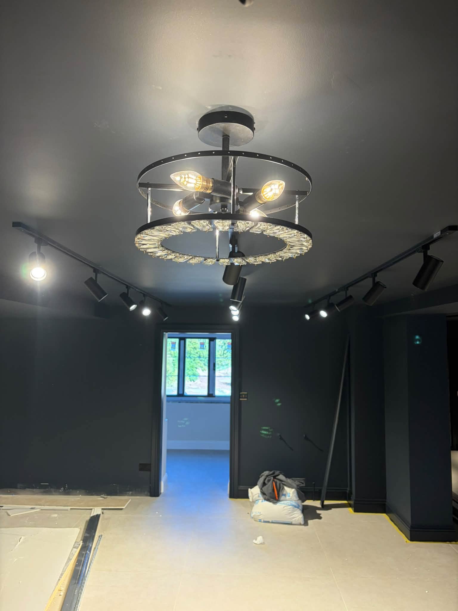Track spots and a circular feature light in a room still being finished